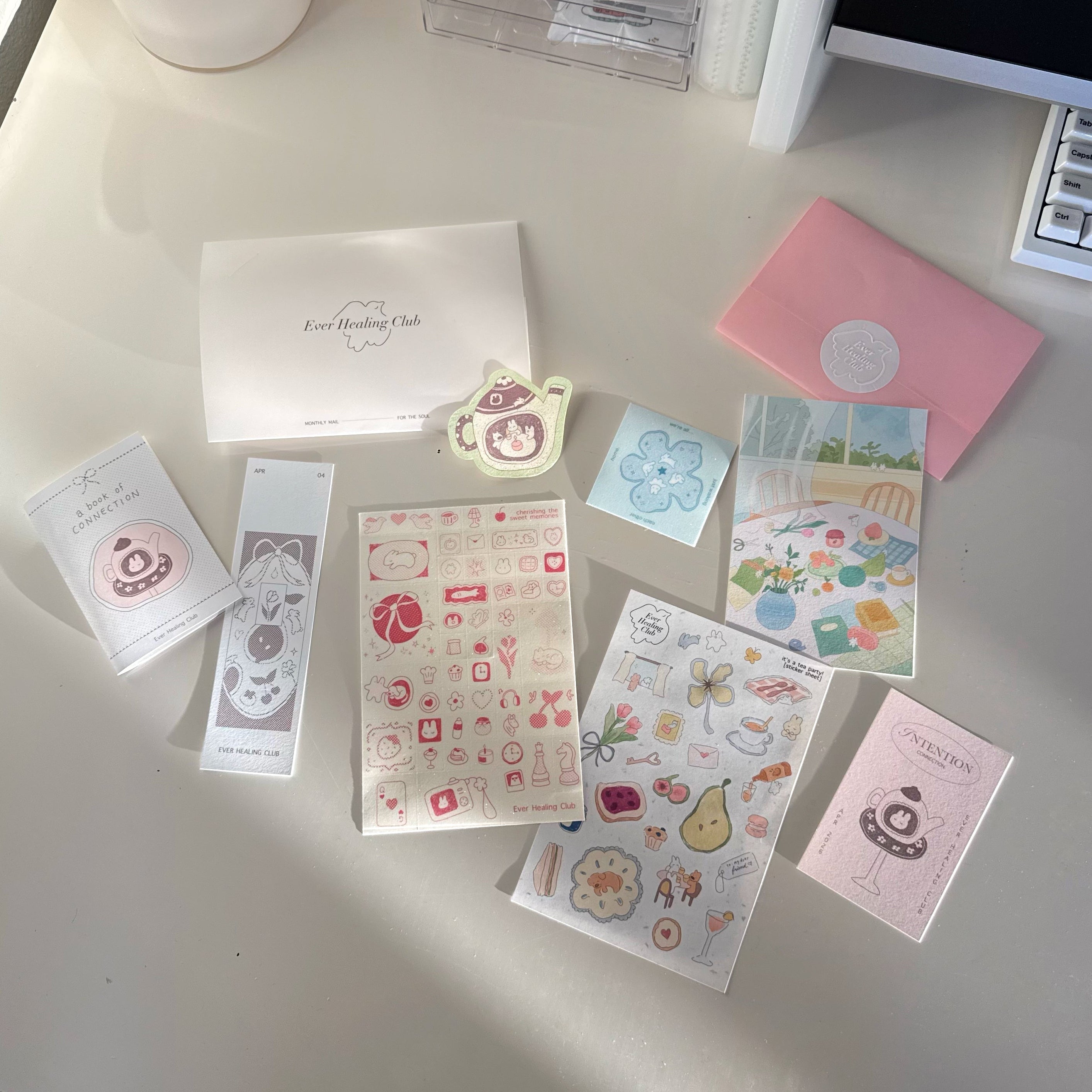 Collection of stationery items including cards and stickers on a light surface. Signature