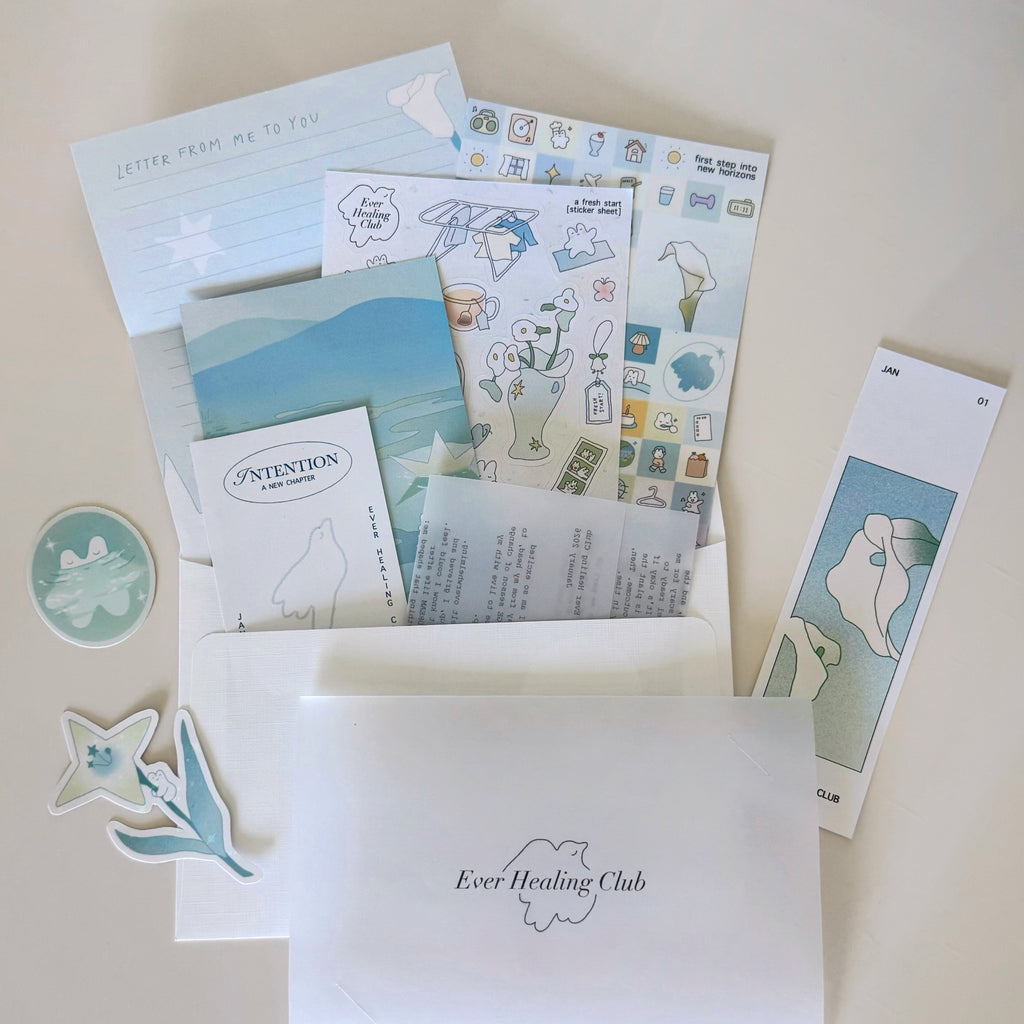 Collection of stationery items with 'Ever Healing Club' branding on a light background. Signature