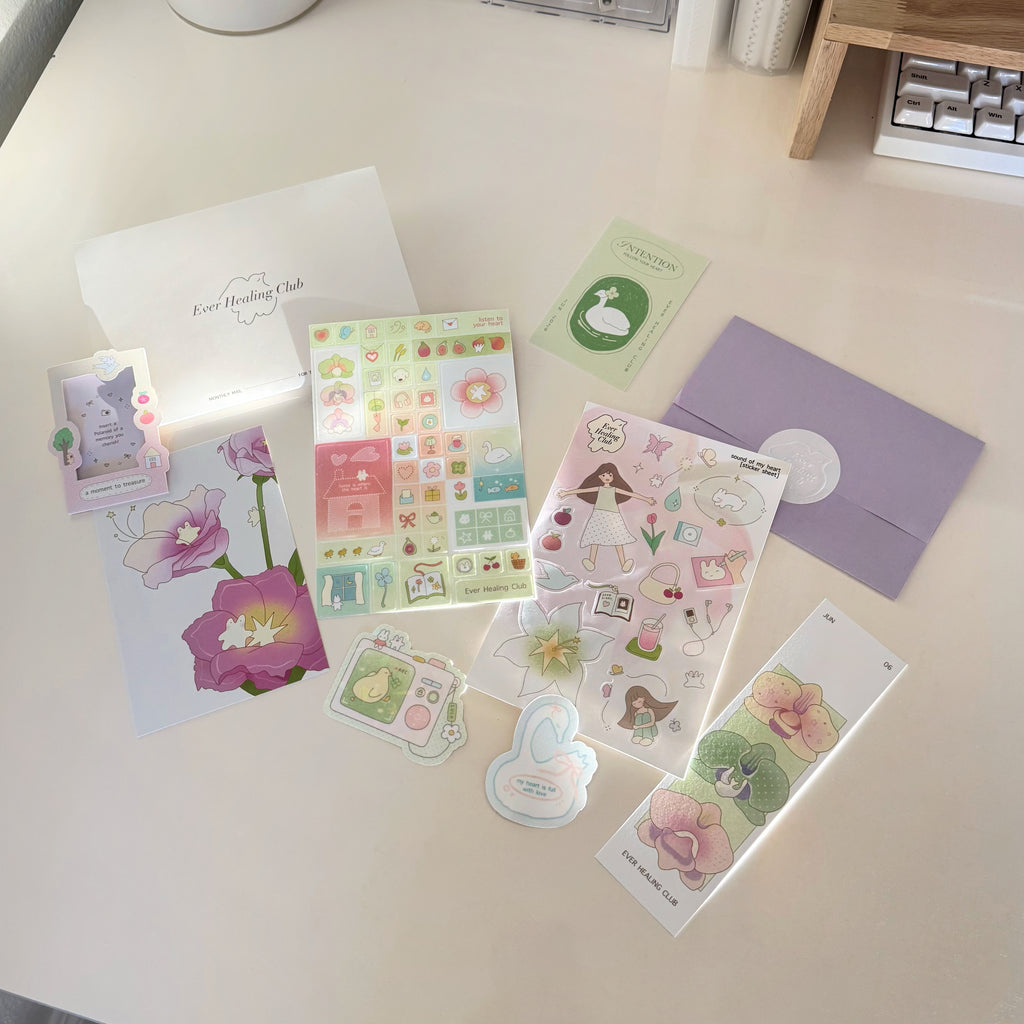 Collection of items from the ever healing club including stickers, a postcard, and a letter. Signature